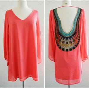 Coral shift dress with geometric crochet back